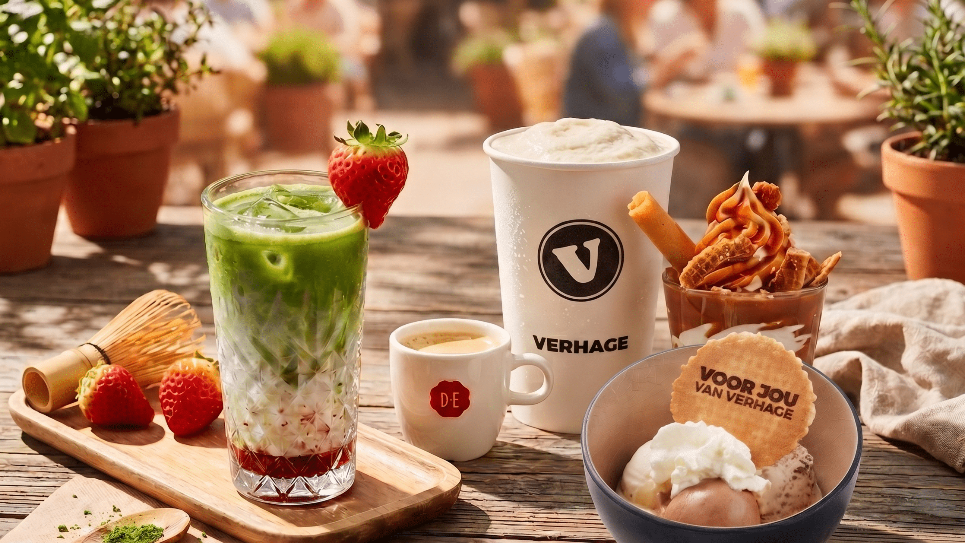 Zomerse Verhage producten met ijs, een milkshake, koffie en matcha op een zonnig terras.